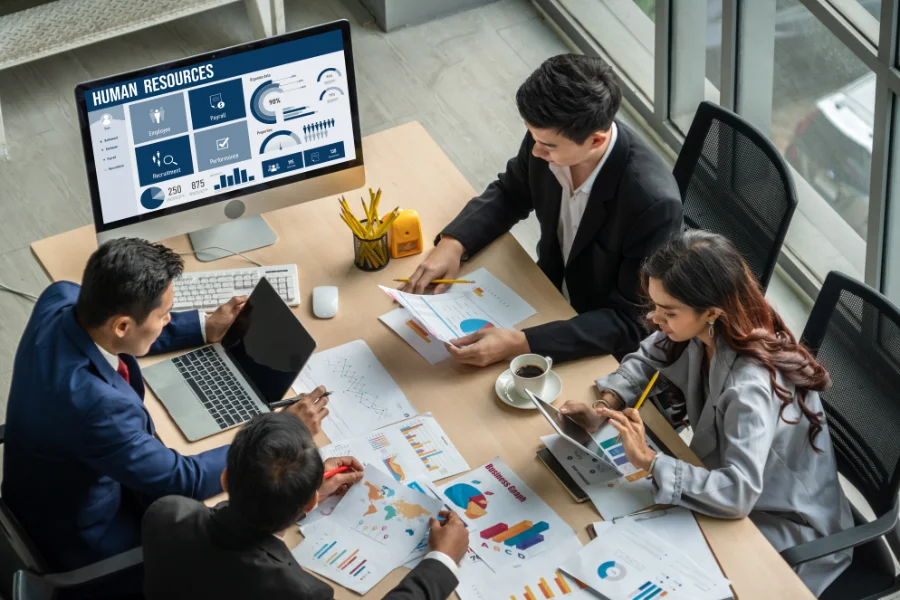 Human resources management software on computer screen helping human resources employee to manage recruitment, payroll, staff searching and KPI evaluation snugly