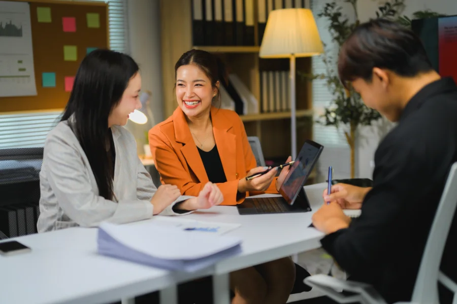 Business team analyzing financial data and working together on a project using tablet in the office