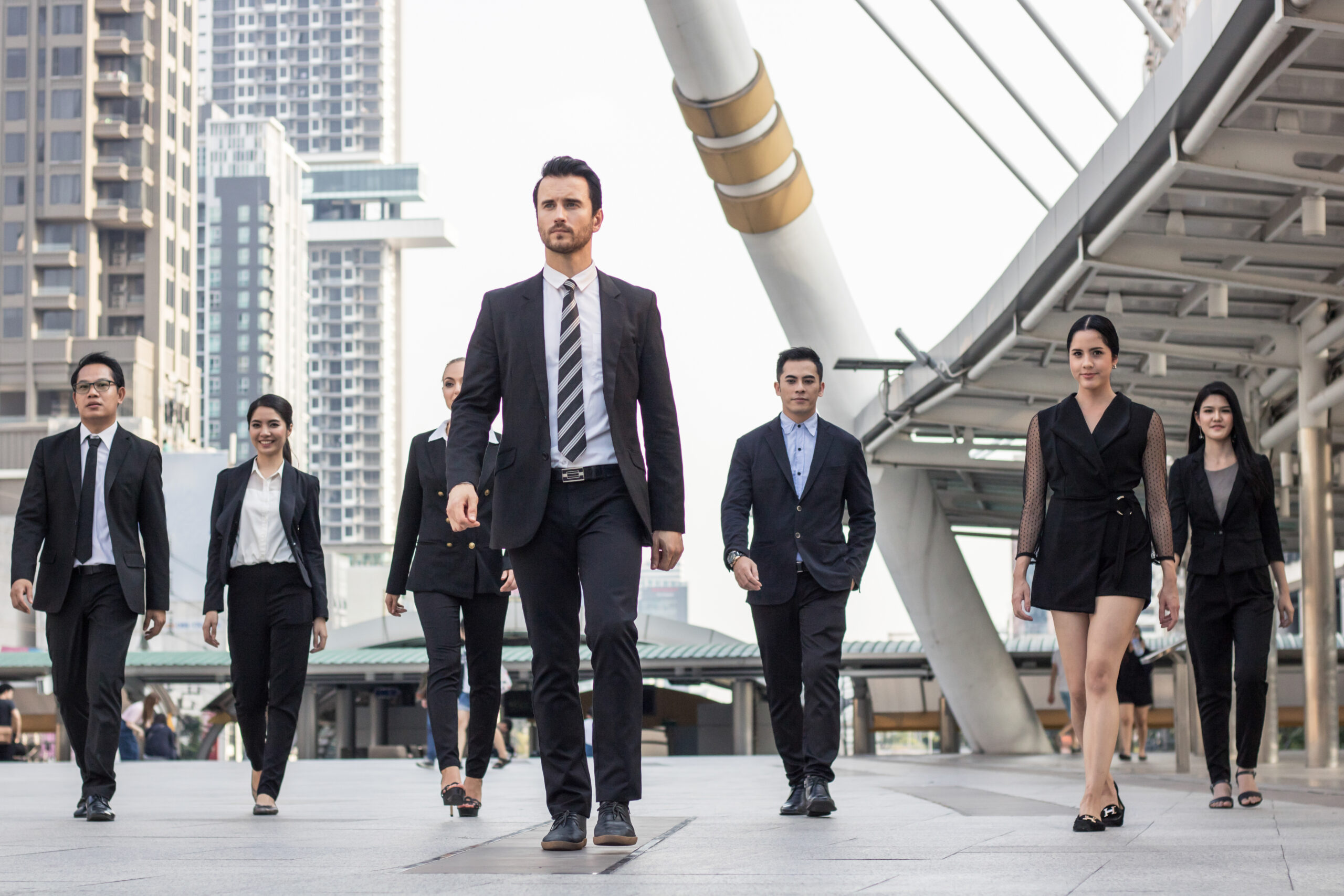 Diverse business team walking with purpose to reflect strong career advancement strategies.